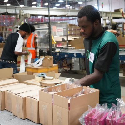 Employee working in packaging at Accel